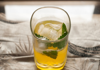 yellow drink with ice and mint,