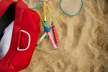 Badminton rackets in the sand of the beach