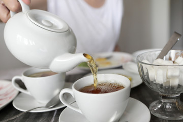 Person pouring tea