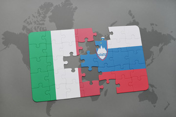 puzzle with the national flag of italy and slovenia on a world map background.