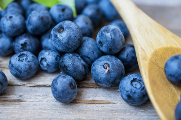Blueberry on the wooden table with a spoon at a kitchen in village
