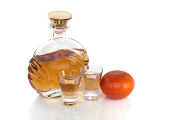 Bottle with glasses tequila and tangerine on white background