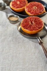 three grapefruit halves on the frying-pans