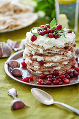 a heap of pancakes smeared with curd and jam