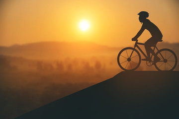 Silhouette of a man on muontain-bike, sunset