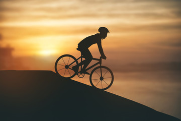 Fototapeta premium Silhouette of a man on muontain-bike, sunset