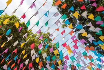 Bunting colorful flags under trees