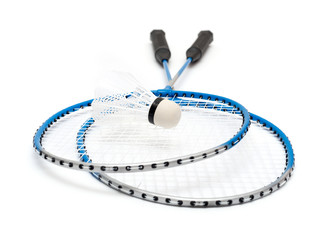 child's hand holding a badminton racket on a white