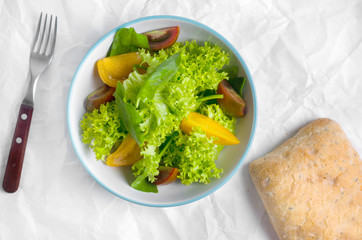 Healthy vegetarian salad with tomatoes in a bowl