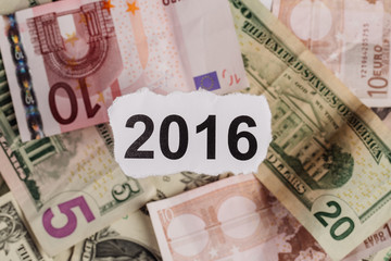 Focus on the words 2016 on piece of torn white paper with USD.
