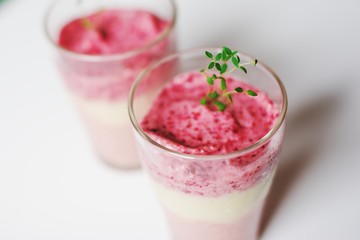 Frozen strawberry smoothie sorbet in glass cups, top view.