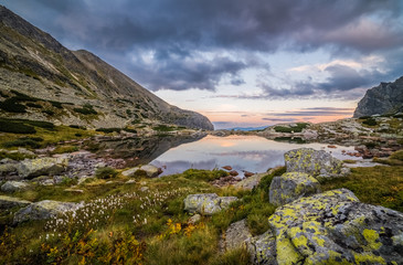 Mountain Lake Above Skok Waterfall with Rocks in Foreground at Sunset. Mlynicka Valley, High Tatra, Slovakia. © kaycco