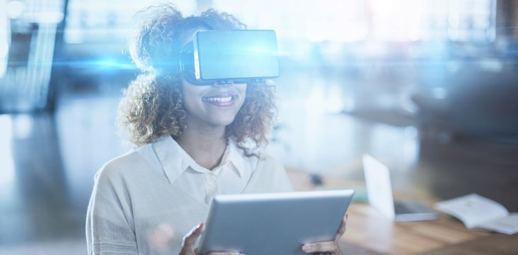 Woman wearing virtual reality glass with digital tablet