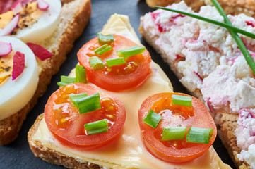 Mix of sandwiches on a stone board