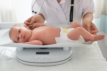 Doctor Checking Weight Of Baby