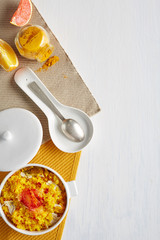 a top view of a cooking pot with rice and chicken curry