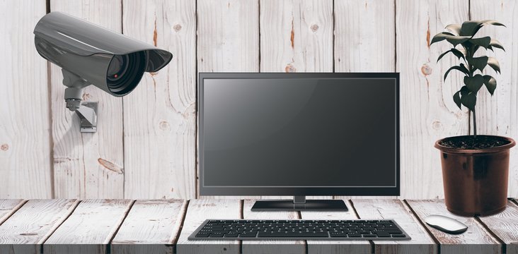 Composite image of a computer over a desk 