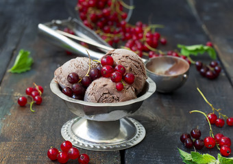 Chocolate ice cream with berries on a dark background