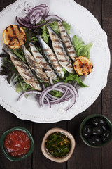 Grilled sardine fish with lemon and lettuce