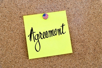 Written text Agreement over yellow paper note