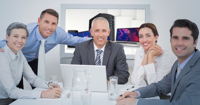 Composite image of business team looking at camera