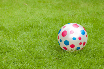 Fancy Football Polka dots, blue and red Put on a green lawn