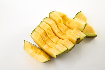 Hamigua Melon cut into slices, Hami Melon, Hami Cantaloupe isolated on white background.