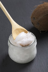 Coconut oil in a glass jar on a black