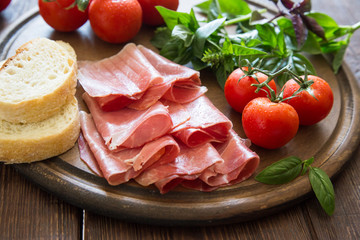 Antipasto with ham and bresaola. tomato and basil. 