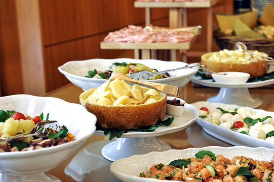 Variety of meat, fish and side dishes on a buffet