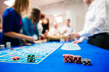 green roulette table with colored chips ready to play