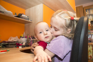 Young girl and her brother in the room