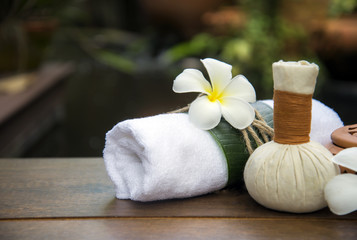 Obraz na płótnie Canvas Spa massage compress balls, herbal ball on the wooden with treaments spa , Thailand, soft focus 