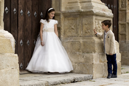Girl and boy outside church before first communion