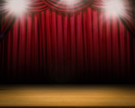 red curtain blurred background with shining spotlight on stage