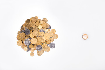 one euro and bunch of ukrainian coins