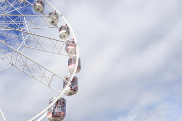 Part of the Ferris Wheel in the cloudy sky