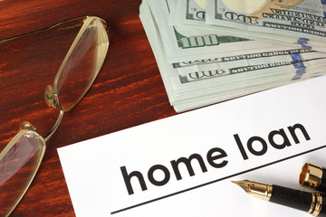 Paper with words home loan on a wooden background.