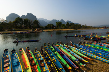 Fototapeta na wymiar Many boats with Song river in Vang Vieng, Laos