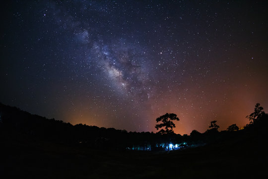 milky way and silhouette of Tree with cloud. Long exposure photo