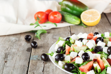 Greek salad closeup. Ingredients in background