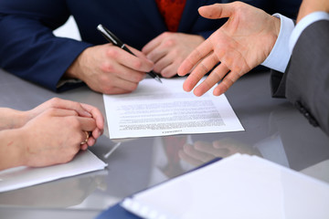Business people discussing contract. Close up of male hand pointing to the paper