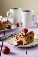 Summer light cake with strawberries on a lilac wooden background with fresh berries 