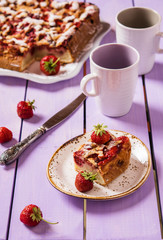 Summer light cake with strawberries on a lilac wooden background with fresh berries 