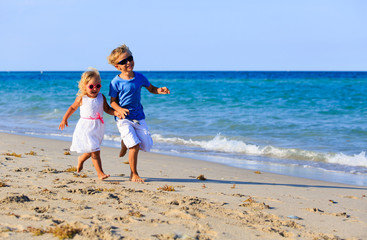 little boy and girl running at beach