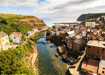 STAITHES, ENGLAND - JULY 12: View of Staithes, from a high viewpoint, showing the beck and the town. In Staithes, North Yorkshire, England. On 12th July 2016.
