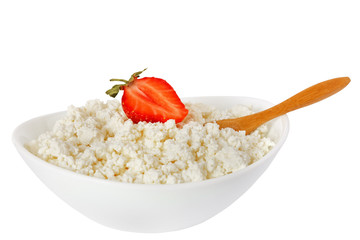 cottage cheese with a strawberry and the wooden spoon in a white bowl isolated on a white background - with clipping path - 115854408