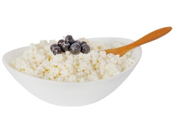 cottage cheese with blueberries and the wooden spoon in a white bowl isolated on a white background - with clipping path - 115854413