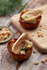 two tartelettes stuffed with mushrooms and peanuts