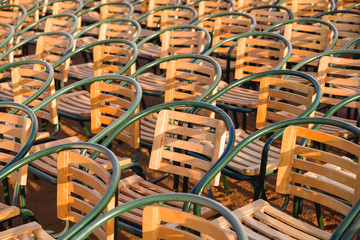 Wooden chairs. Empty stools without people. Concept photo - absence of audience.